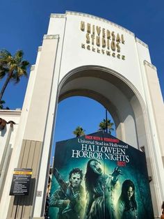 the entrance to universal studios'halloween horror nights with a giant poster on it and palm trees in the background