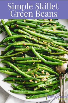 a white plate topped with green beans covered in seasoning