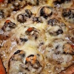 a close up of a pizza with cheese and meat