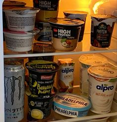 an open refrigerator filled with ice cream and yogurt