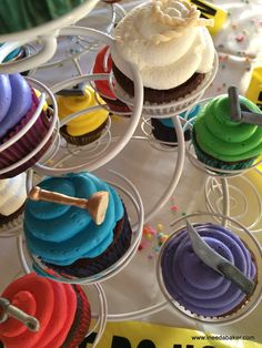 cupcakes with colorful frosting are on display