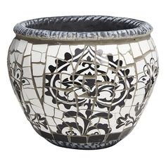 a black and white vase with designs on the outside, sitting in front of a white background