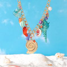 Golden days, starry nights, and sun-kissed jewelry. Elevate your style this summer with Selenichast jewelry. Boho Beach Vibes: Sea Shell Necklace. Channel your inner mermaid with this delightful Shell Charm Necklace. It features an assortment of sea shells, ceramic beads, and freshwater pearls, all strung on a delicate chain. The perfect beach accessory, this charms necklace adds a touch of boho chic to any outfit. Wear it with a flowing summer dress or swimsuit for a touch of coastal flair, or Flowing Summer Dresses, Shell Charm Necklace, Sea Shell Necklace, Ocean Fashion, Starry Nights, Golden Days, Charms Necklace, Bunny Gifts, Seashell Necklace