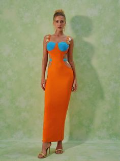 Margaux Embellished Cutout Maxi Dress in Orange Step into the spotlight with the Margaux Embellished Cutout Maxi Dress. This stunning dress combines elegance and allure through its unique design elements, making it perfect for special occasions or nights out on the town. Dress Details The Margaux dress is crafted from a luxurious bandage material featuring 95% polyester and 5% spandex for a comfortable fit. Its intricate cutout design and metal embellishments add an extra layer of sophistication Simple Accessories, Cutout Maxi Dress, Club Party Dresses, Jumpsuits And Romper, Clear Heels, Feather Dress, Maxi Dress Green, Green Material, Cut Out Design