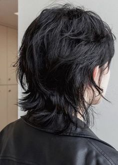 the back of a person's head wearing a black leather jacket and short hair