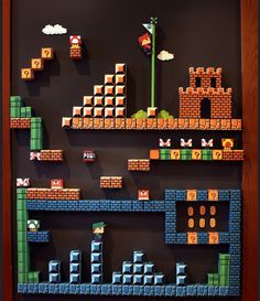 an image of a mario bros game displayed on a blackboard with wood frame and paper cut outs