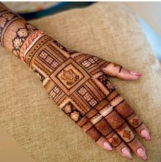 a woman's hand is decorated with intricate designs