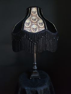 a lamp with black fringes and skulls on it