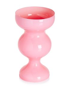 a pink vase sitting on top of a white table