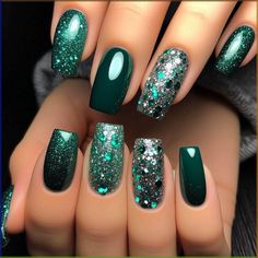 Most nails are painted with a deep, luxurious emerald green polish. The ring fingers feature a striking glitter accent, combining emerald and silver glitter for a dazzling effect. The glitter is densely packed, creating a sparkling contrast against the solid emerald nails. The overall look is glamorous and eye-catching. Glitter Emerald Green Nails, Slytherin Green Nails, Emerald Green Silver Nails, Dark Green And Purple Nails, Emerald Green Holiday Nails, Emerald Green Nails With Silver, Dark Teal Nail Ideas, Emerald Green Glitter Nails, Nails That Go With Green Dress