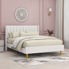 a white bed sitting next to a pink wall in a room with a rug on the floor