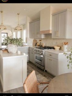 a kitchen with white cabinets and silver appliances