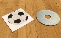 a piece of paper with a soccer ball on it next to a hole in the floor