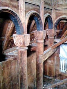 an old wooden building with arches and pillars