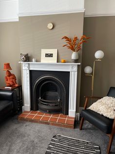 a living room filled with furniture and a fire place in the middle of the room