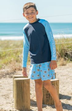 They can sport classic surf style in this raglan-sleeve rashguard top with quick-drying fabric, built-in sun protection and a standout colorblocked design. Crewneck Long sleeves UPF 50+ sun protection 80% polyamide, 20% elastane Machine wash, line dry Imported Kids Swim Shorts, Toddler Swimming, Boys Swim Shorts, Surfer Dude, Boys Sleepwear, Long Sleeve Rashguard, Swim Short, Fish Swimming, Boys Swimwear