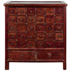 an old wooden chest with many drawers and knobs on the front, against a white background