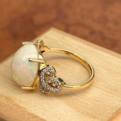 Very large statement ring! Vintage 18KT yellow gold cabochon opal and diamond filigree design ring. Size 7.75 Can be resized for an additional fee Stone measures: 13.9mm x 11.9mm Stamped 18k & iliana .40 ct natural diamonds; SI/ H-I Very Good Condition Luxury Oval Cabochon Opal Promise Ring, Luxury Cabochon Opal Promise Ring, Luxury Cabochon Diamond Ring Gift, Luxury Spiritual Oval Cabochon Rings, Luxury Oval Cabochon Opal Engagement Ring, Luxury Modern Cabochon Opal Ring, Luxury Southwestern Oval Rings, Luxury Cabochon Opal Ring For Wedding, Luxury Oval Cabochon Opal Ring