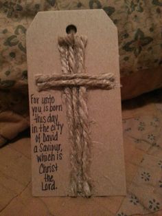 a cross is wrapped in twine with a bible verse on it