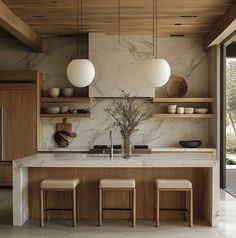 a kitchen with marble counter tops and wooden shelves on the wall, along with stools