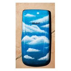 a cell phone case with clouds painted on it