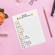 a notepad with emojtchery written on it next to a cup of flowers