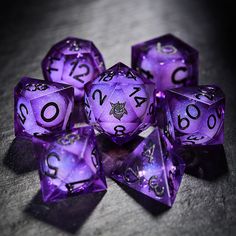 purple dice with numbers on them sitting on a table