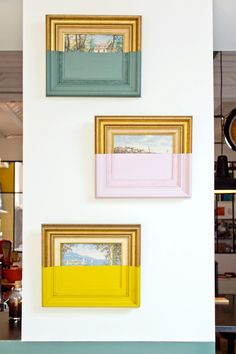 three different colored frames hanging on the wall