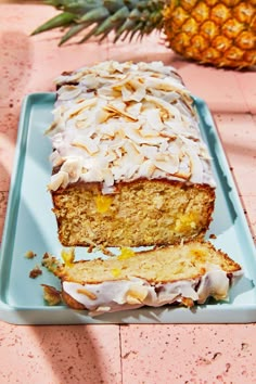 a pineapple cake with white frosting on a blue plate