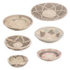 four woven baskets with different designs on the bottom and one has an oval design in the middle