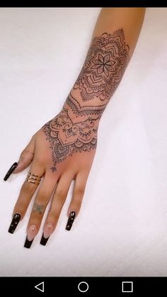 a woman's hand with tattoos on it