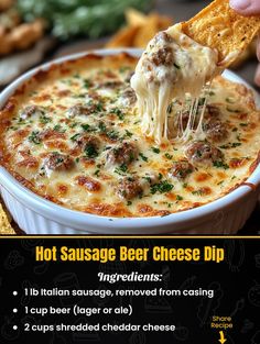 hot sausage beer cheese dip recipe in a white bowl with a hand holding a piece of bread