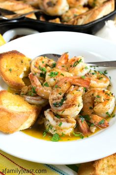 a white plate topped with shrimp and bread