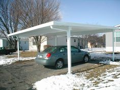 a car is parked in the driveway under a white awning over it's roof