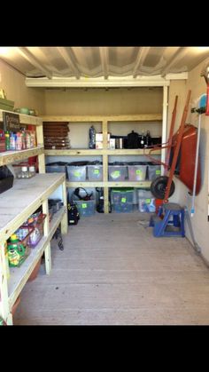 the inside of a garage with shelves and tools