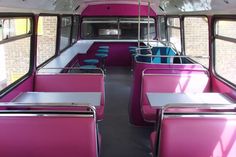 the inside of a bus with pink seats