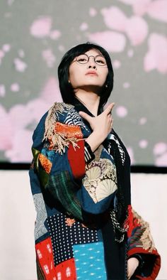 a woman with her hands folded in prayer