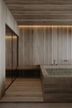 a large bath tub sitting inside of a wooden room next to a wall mounted shower