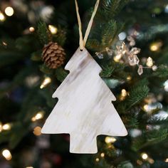 a wooden ornament hanging from a christmas tree