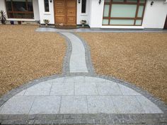 a stone walkway in front of a house