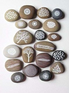 a group of rocks with different designs and shapes in the shape of trees on them