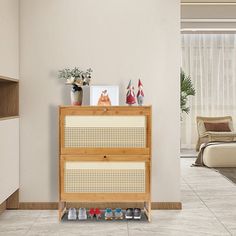 a wooden cabinet with shoes on it in a living room