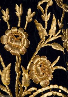 gold embroidered flowers on black velvet fabric with golden threadwork and sequins in the center