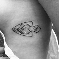 a black and white photo of a fish tattoo