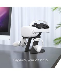 a white robot sitting on top of a desk next to a computer