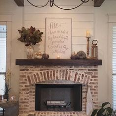 a living room with a fire place and a sign on the wall