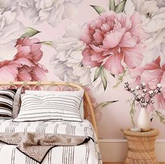 a bedroom with pink flowers painted on the wall