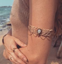 a woman wearing a bracelet on the beach