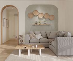 a living room filled with furniture next to a wall mounted art piece on the wall