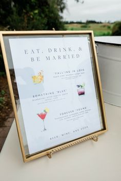 a sign that says eat drink and be married sitting on top of a white table